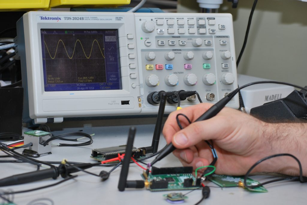 Close up of person fixing an electronic device.